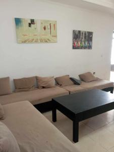 Sala de estar con 2 sofás y mesa de centro en Le petit VIP, en Aïn El Turk