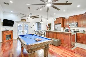 a kitchen with a pool table in a room at 5 Mi to Bourbon St NOLA Home with Fenced Yard! in New Orleans