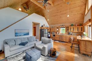 a living room with a couch and a kitchen at Catskills Cabin Rental with Hot Tub and Amazing Views! in Stamford +28 photos