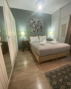 a bedroom with a bed with two towels on it at Marina Zeas Seaside Studio-MarinaQ in Piraeus