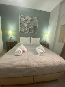 a bedroom with a bed with towels on it at Marina Zeas Seaside Studio-MarinaQ in Piraeus