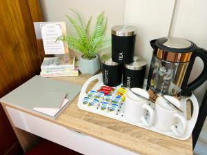 un mostrador con cafetera y tazas en LEITH WALK VILLA budget guest house, en Edimburgo