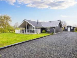 a house with a gravel driveway in front of it at Three-Bedroom Holiday home in Hemmet 26 in Hemmet