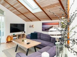 a living room with a purple couch and a table at Three-Bedroom Holiday home in Hemmet 26 in Hemmet