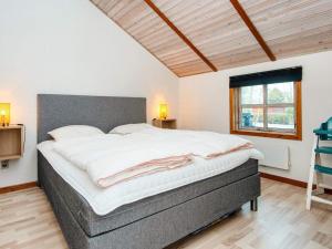 a bedroom with a large bed in a room at Three-Bedroom Holiday home in Hemmet 26 in Hemmet