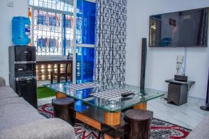 a living room with a glass table and a couch at SUNCOAST HOMES in Mtwapa