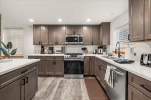 a kitchen with wooden cabinets and a stove top oven at Perch - Mowich Cozy in Ashford