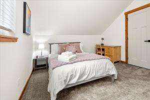 a bedroom with a bed and a desk and a door at Perch - Mowich Cozy in Ashford
