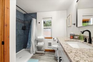 a bathroom with a tub and a sink and a toilet at Perch - Mowich Cozy in Ashford