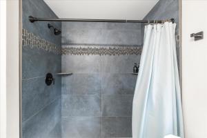 a bathroom with a shower with a shower curtain at Perch - Mowich Cozy in Ashford