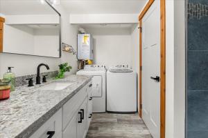 a small kitchen with white appliances and a sink at Perch - Mowich Cozy in Ashford +29 photos