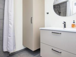 a bathroom with a sink and a mirror at 8 person holiday home in Skjern-By Traum in Skjern +36 photos