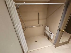 a small bathroom with a shower and a toilet at Best Western Plus Chicagoland - Countryside in Countryside +17 photos
