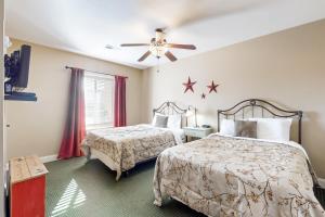 a bedroom with two beds and a ceiling fan at Summit Manor Condos Unit B3062 in Gatlinburg +24 photos