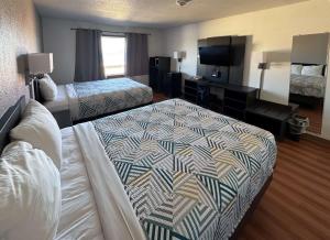 a hotel room with two beds and a flat screen tv at Motel 6-Fond Du Lac, WI in Fond du Lac