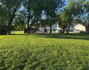 a park with a picnic table in the grass at Motel 6-Fond Du Lac, WI in Fond du Lac