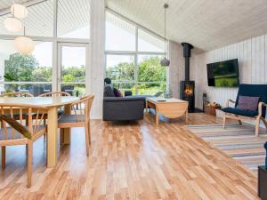 a living room with a table and chairs and a fireplace at Holiday home Tarm XLIV in Tarm
