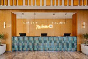 a lobby of a hotel with a reception desk at Radisson Blu Resort Al Hoceima in Al Hoceïma