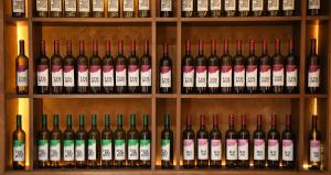 a bunch of wine bottles on a shelf at KOKINO Hotel & Winery in Kumanovo