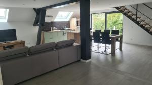 a kitchen and living room with a table and chairs at Appartement en duplex avec 2 chambres in Sint-Genesius-Rode