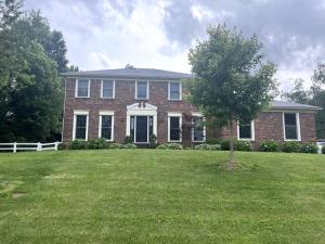 a large brick house with a tree in the yard at Shallow Creek Suite in River Bluff