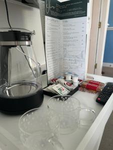 a kitchen counter with a blender and glasses on it at Olive Restaurant and Wine bar in Tottington