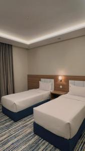 Voodi või voodid majutusasutuse شقق هوليداي بلس مشرفه - Holiday Plus Mishrifah Apartments toas