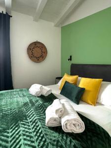 a bedroom with a bed with towels on it at Citroom - green city rooms in Olbia