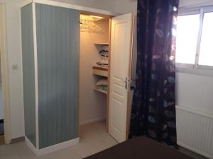 a walk in closet with a door and a window at Appartement Miramar in Banyuls-sur-Mer