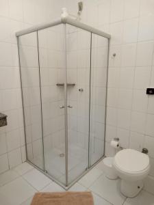a glass shower in a bathroom with a toilet at BLUES HOTEL in Guaratinguetá