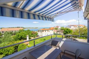 a balcony with a view of the water at Apartments and rooms with parking space Nin, Zadar - 5805 in Nin