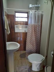 a small bathroom with a toilet and a sink at Sítio pousada e Refúgio lazer e eventos in Santana do Livramento