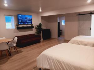 a hotel room with two beds and a flat screen tv at Five10 Orange Street Hotel - Hot Springs in Hot Springs