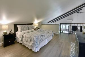 a bedroom with a bed and a wooden floor at Stunning Condo - View on Lake Tremblant & Mountain in Mont-Tremblant