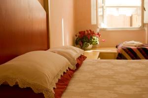 a bedroom with a bed and a window and a flower pot at La Tata B&B in Lerici