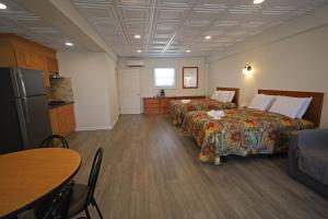 a hotel room with two beds and a kitchen at Compass Family Resort in Wildwood Crest