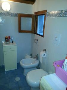 a bathroom with a toilet and a sink at Villa la Ficuzza in Cittadella del Capo