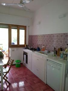 a kitchen with a sink and a stove top oven at Villa la Ficuzza in Cittadella del Capo