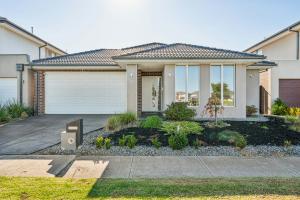 a house with a garage and a driveway at Shine Point Cook - Elegant Home Sweet Home in Point Cook