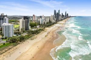 an aerial view of a beach in front of a city at Boulevard Towers on Broadbeach in Gold Coast +29 photos