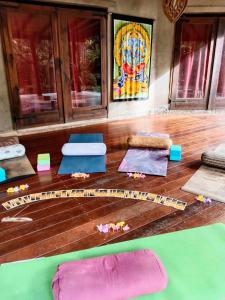 a group of mats on a wooden floor in a room at Soul Rise in Taravao
