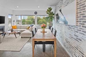 a living room with a brick wall at Soho Penthouse by IRIS PROPERTIES! in Victoria