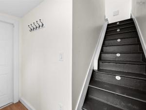 a stairwell with a black and white staircase at Serenity Getaway in Halifax