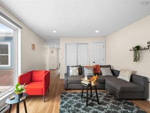 a living room with a couch and a red chair at Serenity Getaway in Halifax +12 photos