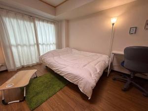 Ένα ή περισσότερα κρεβάτια σε δωμάτιο στο ハイムユアーズ207