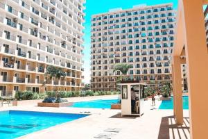 a man standing in a booth next to two tall buildings at RF Condotel in Lapu Lapu City
