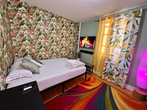 a small room with a bed with a floral wallpaper at queen size room with shared bathroom in New York
