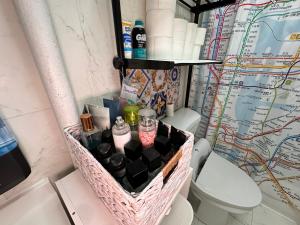 a bathroom with a basket on the toilet at queen size room with shared bathroom in New York