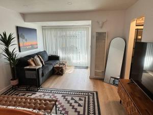 a living room with a couch and a television at Carpinteria Beach Studio Condo in Carpinteria