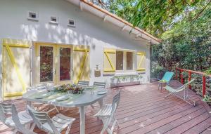a patio with a table and chairs on a deck at Nice Home In Saint-Georges-De-Didon in Saint-Georges-de-Didonne +33 photos